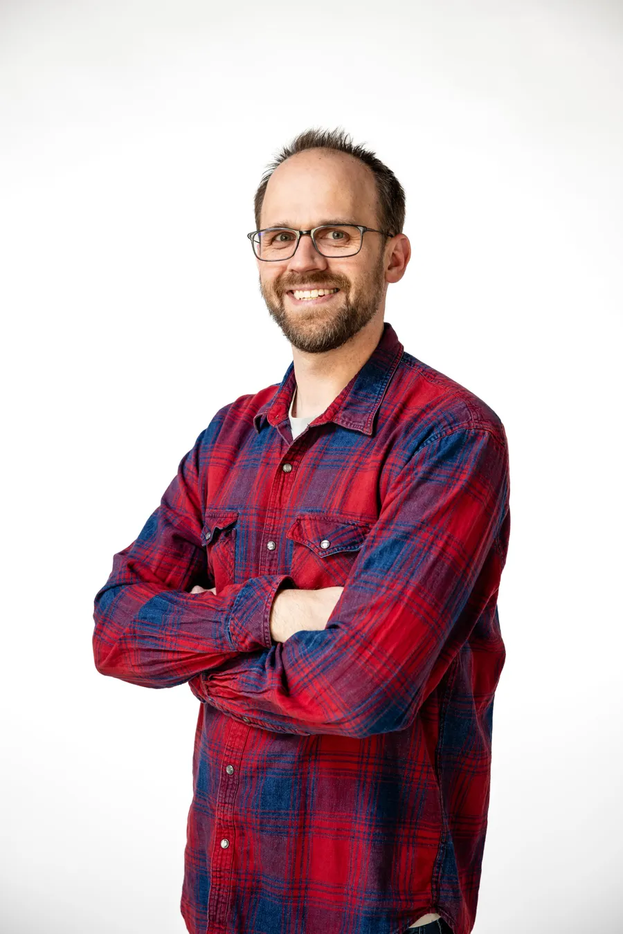 Dr. Adam Milmont smiling with his arms crossed